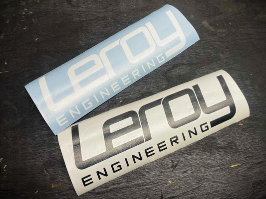 Two 'Leroy Engineering' stickers on a dark surface